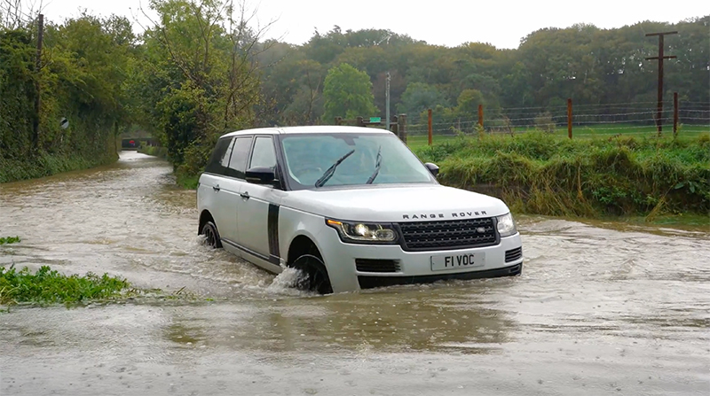 Range Rover driving through flood